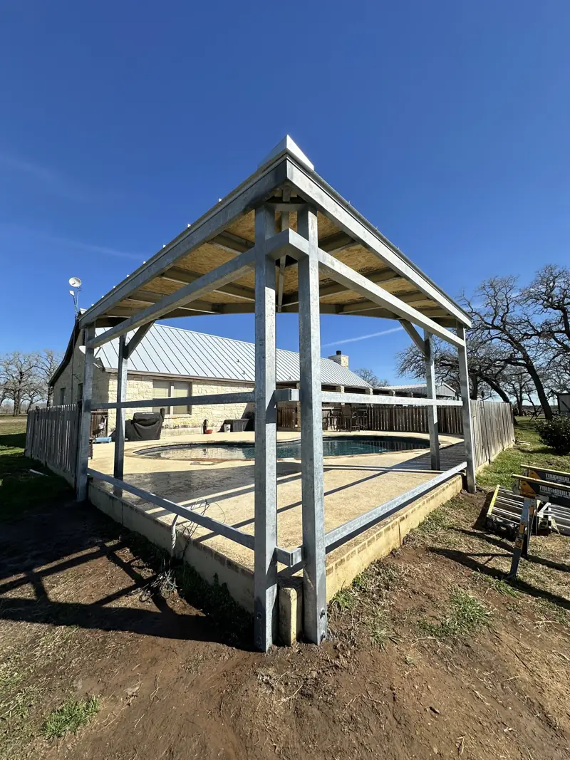 Galvanized steel frame with a roof deck beside the pool.
